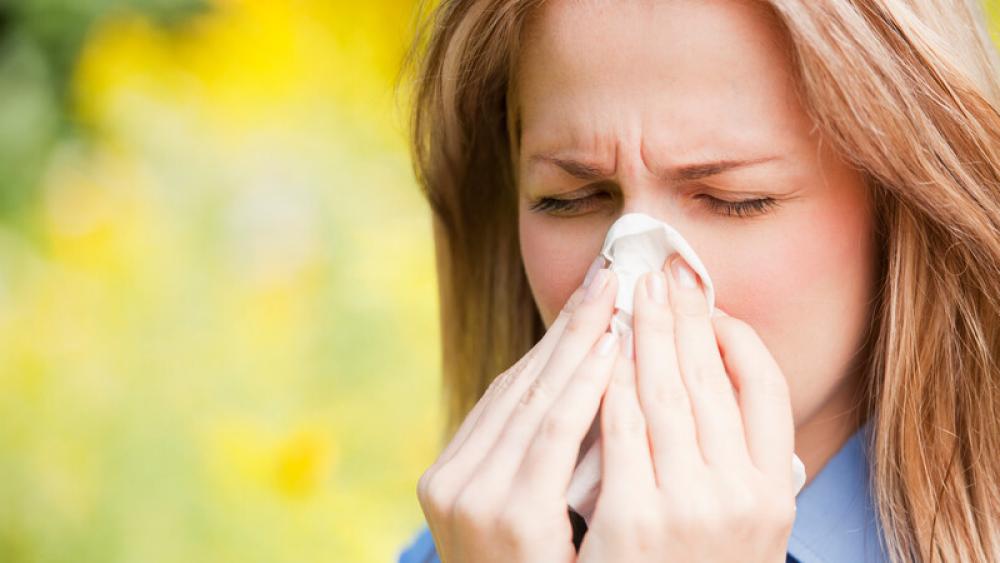 Woman blowing nose